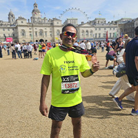 Pasha holding his London Marathon Medal